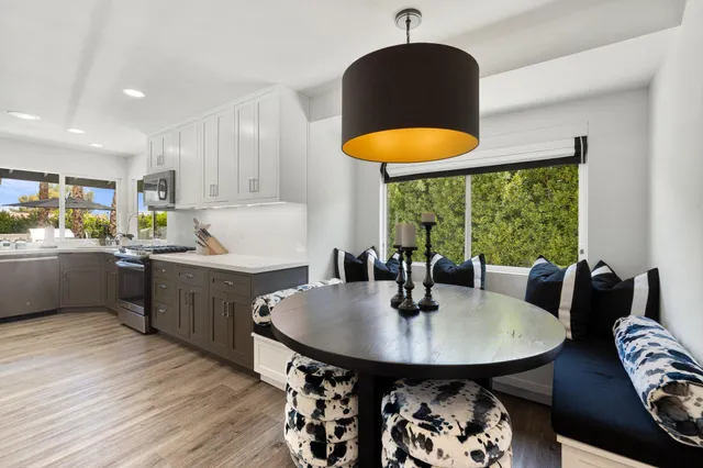 a kitchen with a table chairs sink and cabinets