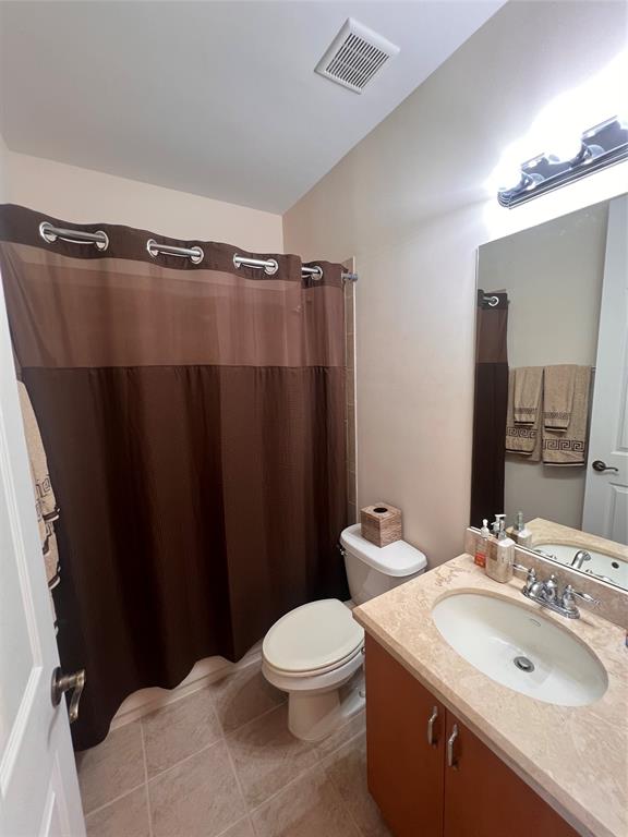 3014 Waterside Circle Boynton Beach, FL 33435 - Photo 13 of 40 a bathroom with a sink a toilet a mirror and vanity