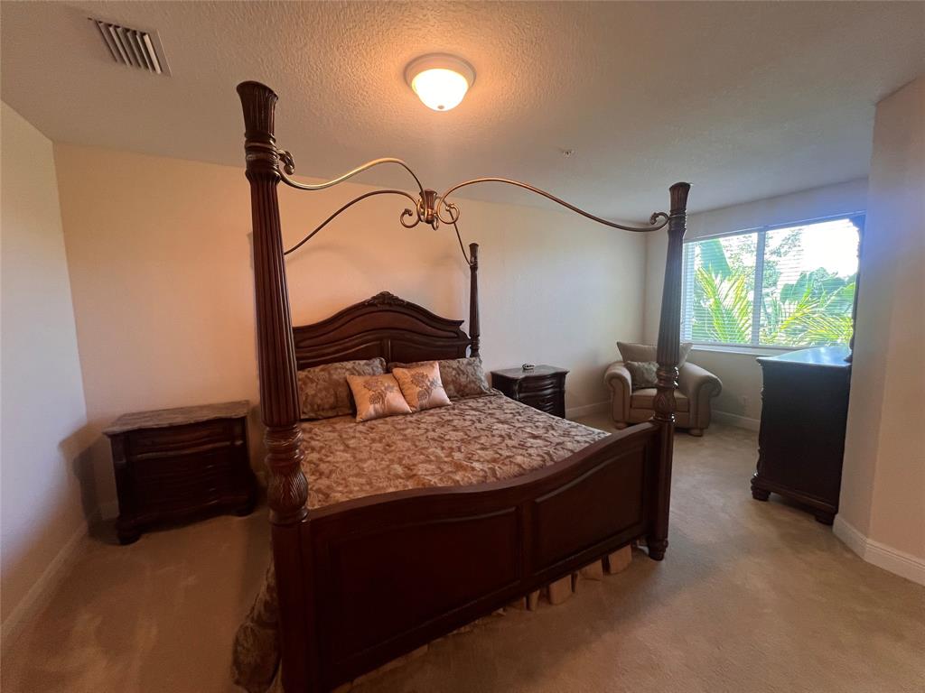 3014 Waterside Circle Boynton Beach, FL 33435 - Photo 14 of 40 a bedroom with a bed window and a table