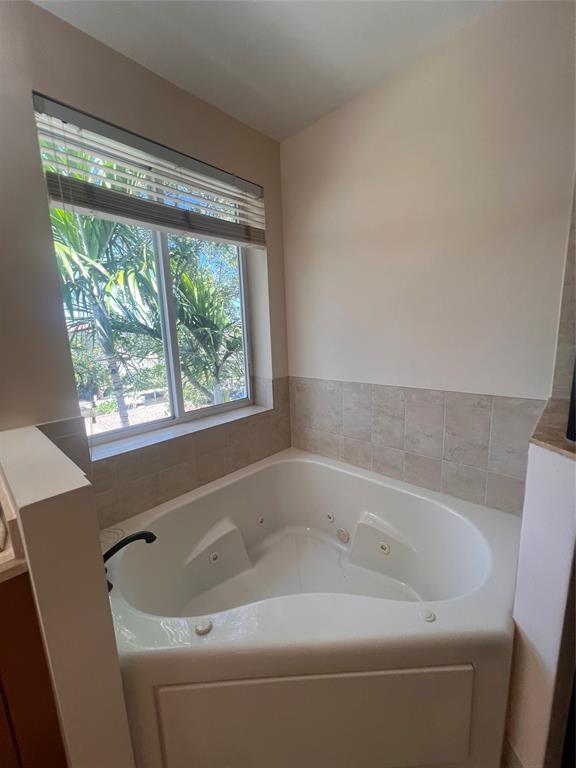 3014 Waterside Circle Boynton Beach, FL 33435 - Photo 18 of 40 a bathroom with a bathtub and window