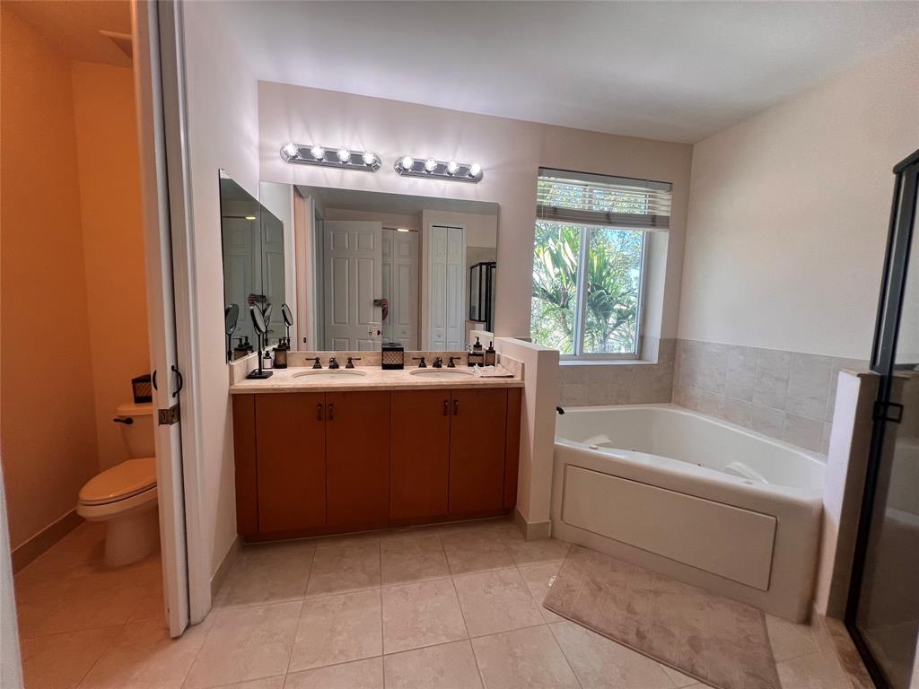 3014 Waterside Circle Boynton Beach, FL 33435 - Photo 20 of 40 a bathroom with a tub a sink and a large mirror