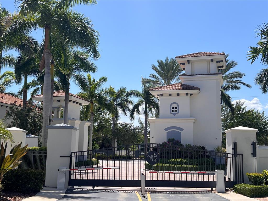 3014 Waterside Circle Boynton Beach, FL 33435 - Photo 35 of 40 a view of a white house with palm trees next to a road