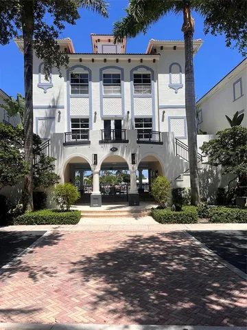 a front view of a house with a yard and outdoor seating