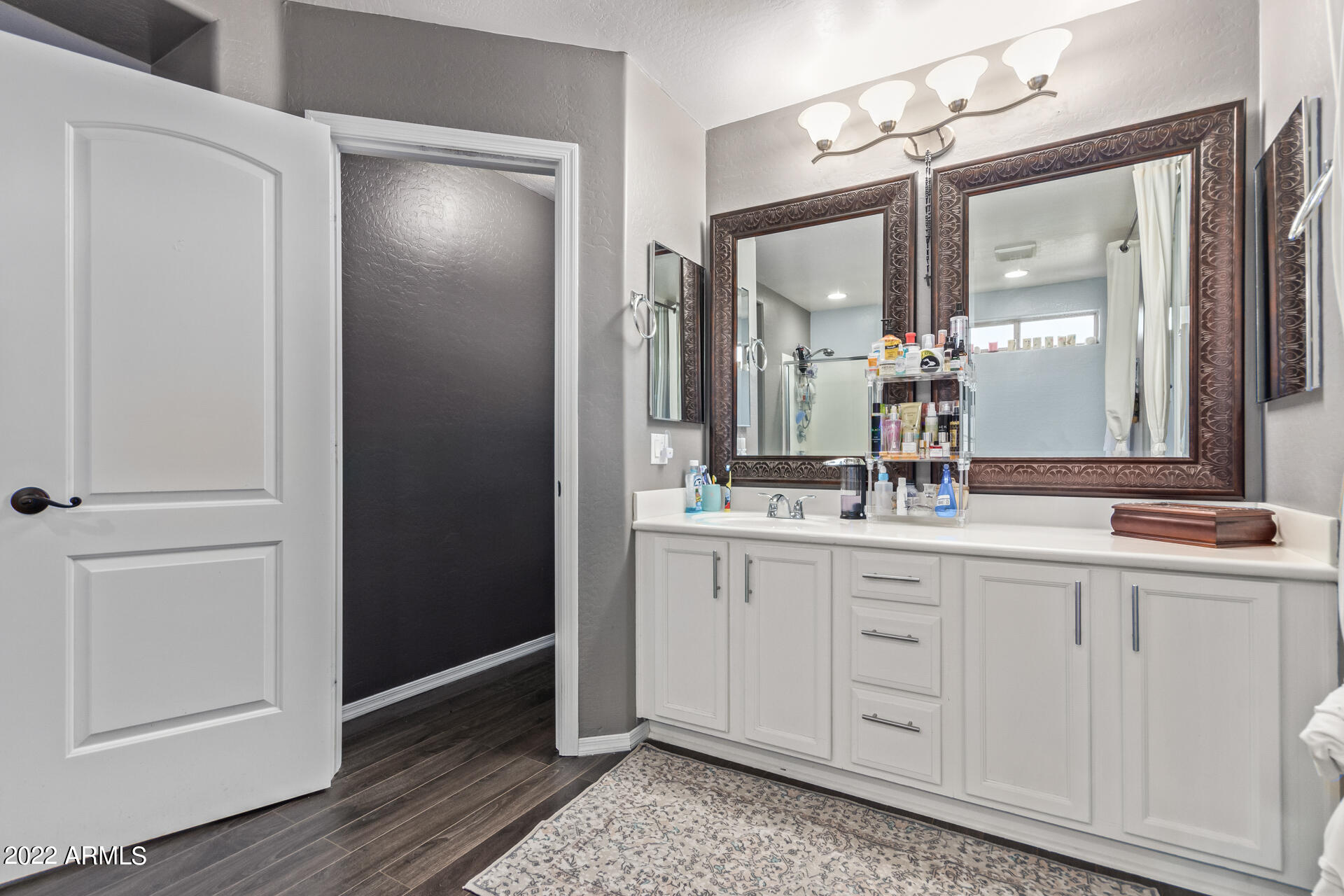 43357 West Magnolia Road Maricopa, AZ 85138 - Photo 34 of 48 a bathroom with a double vanity sink and a mirror