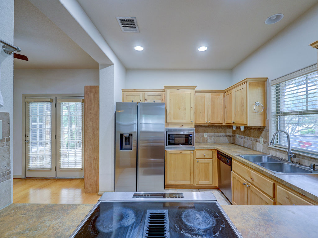 9707 Anderson Mill Road, Unit 22 Austin, TX 78750 - Photo 18 of 39 A functional kitchen boasts ample counter space and well-appointed appliances, ready for culinary endeavors.