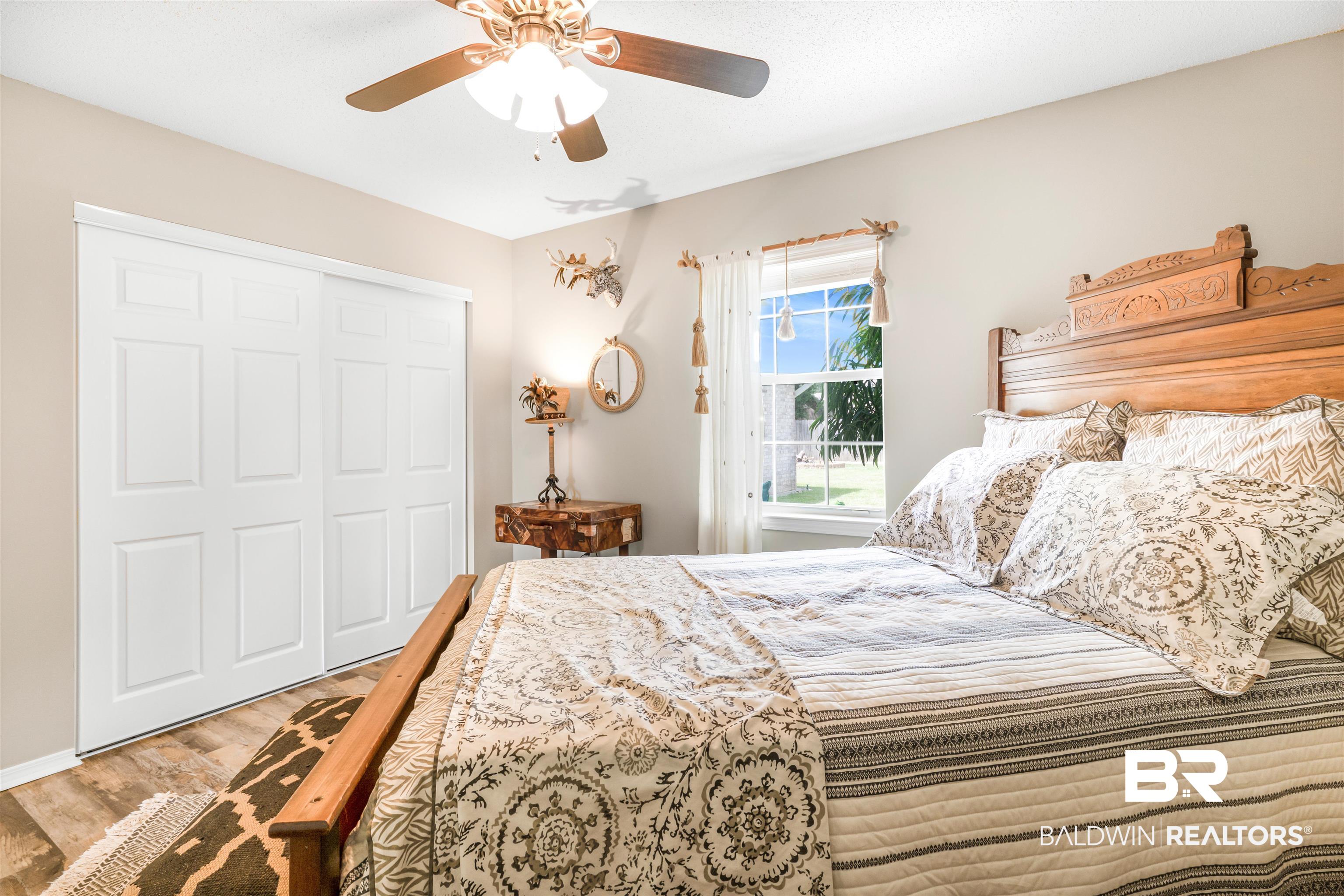 518 Ariel Avenue Foley, AL 36535 - Photo 28 of 47 Bedroom with light hardwood / wood-style flooring, ceiling fan, and a closet