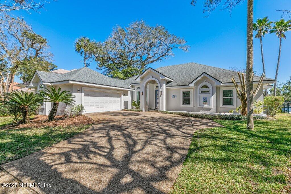 a view of a yard in front of a house with plants