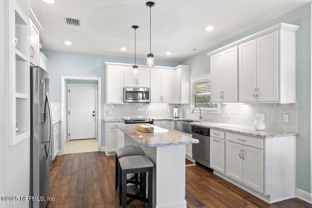 2307 Beachcomber Trail Atlantic Beach, FL 32233 - Photo 19 of 75 a kitchen with a sink window and stainless steel appliances