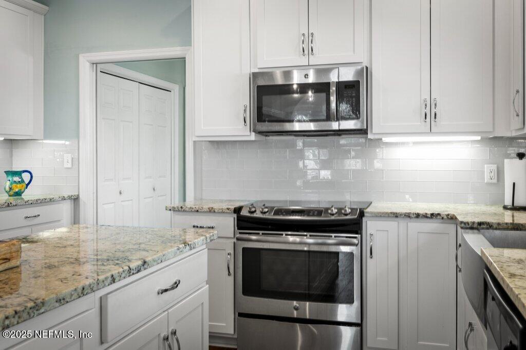 2307 Beachcomber Trail Atlantic Beach, FL 32233 - Photo 21 of 75 a kitchen with granite countertop a stove and a microwave