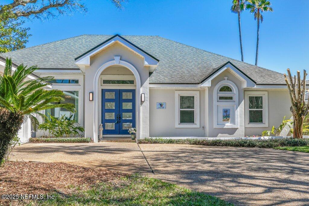 2307 Beachcomber Trail Atlantic Beach, FL 32233 - Photo 3 of 75 a front view of a house with a garden