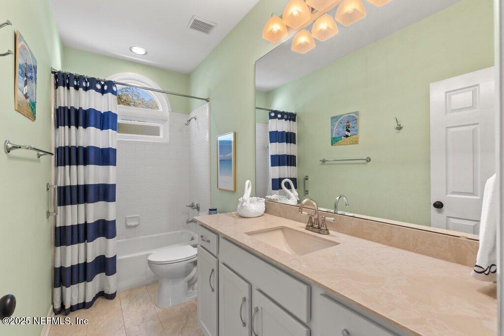 2307 Beachcomber Trail Atlantic Beach, FL 32233 - Photo 37 of 75 a bathroom with a granite countertop sink toilet a shower and a mirror