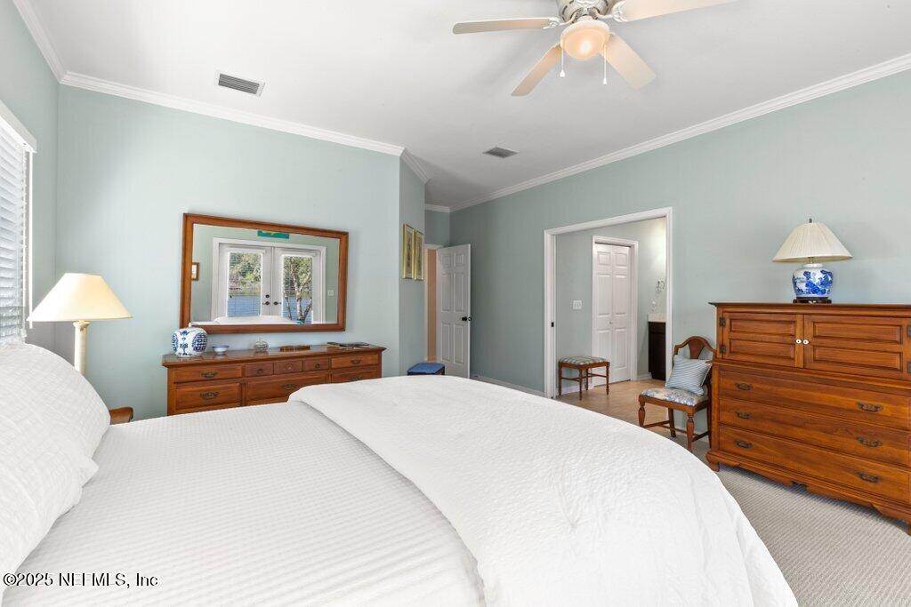 2307 Beachcomber Trail Atlantic Beach, FL 32233 - Photo 44 of 75 a bedroom with a bed and a chandelier