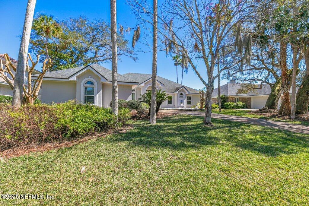 2307 Beachcomber Trail Atlantic Beach, FL 32233 - Photo 7 of 75 a front view of a house with a yard