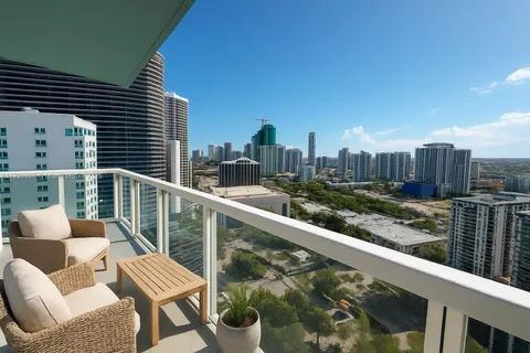 a view of a balcony with two chairs and a potted plant