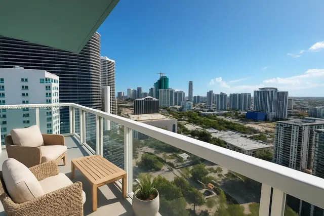 a view of a balcony with two chairs and a potted plant