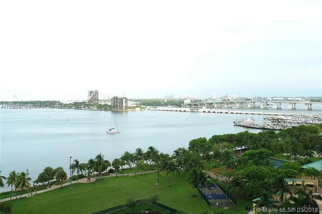 a view of a lake with houses in the back