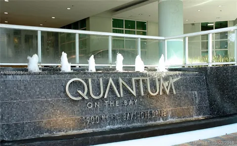 a bathroom with a granite countertop sink and large window