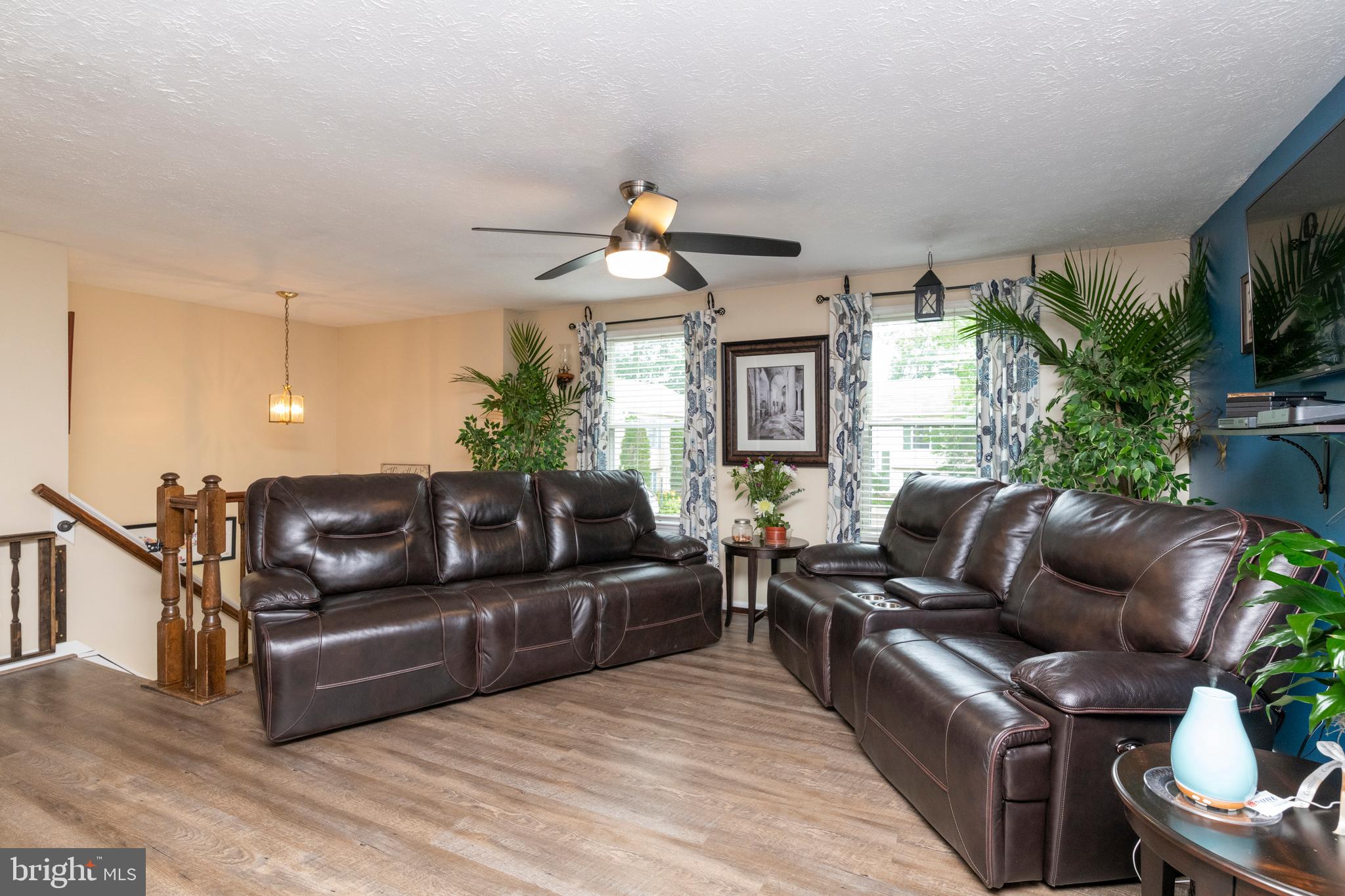 8624 Lawrence Hill Road Perry Hall, MD 21128 - Photo 6 of 39 a living room with furniture a potted plant and a chandelier