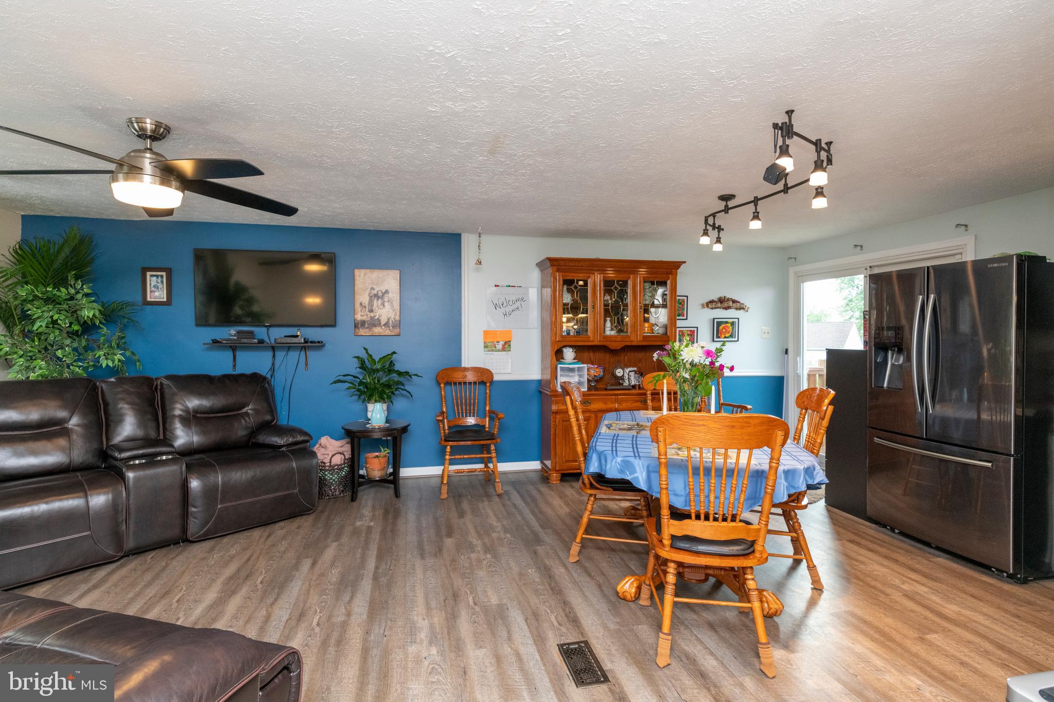 8624 Lawrence Hill Road Perry Hall, MD 21128 - Photo 7 of 39 a living room with furniture a flat screen tv and a fireplace