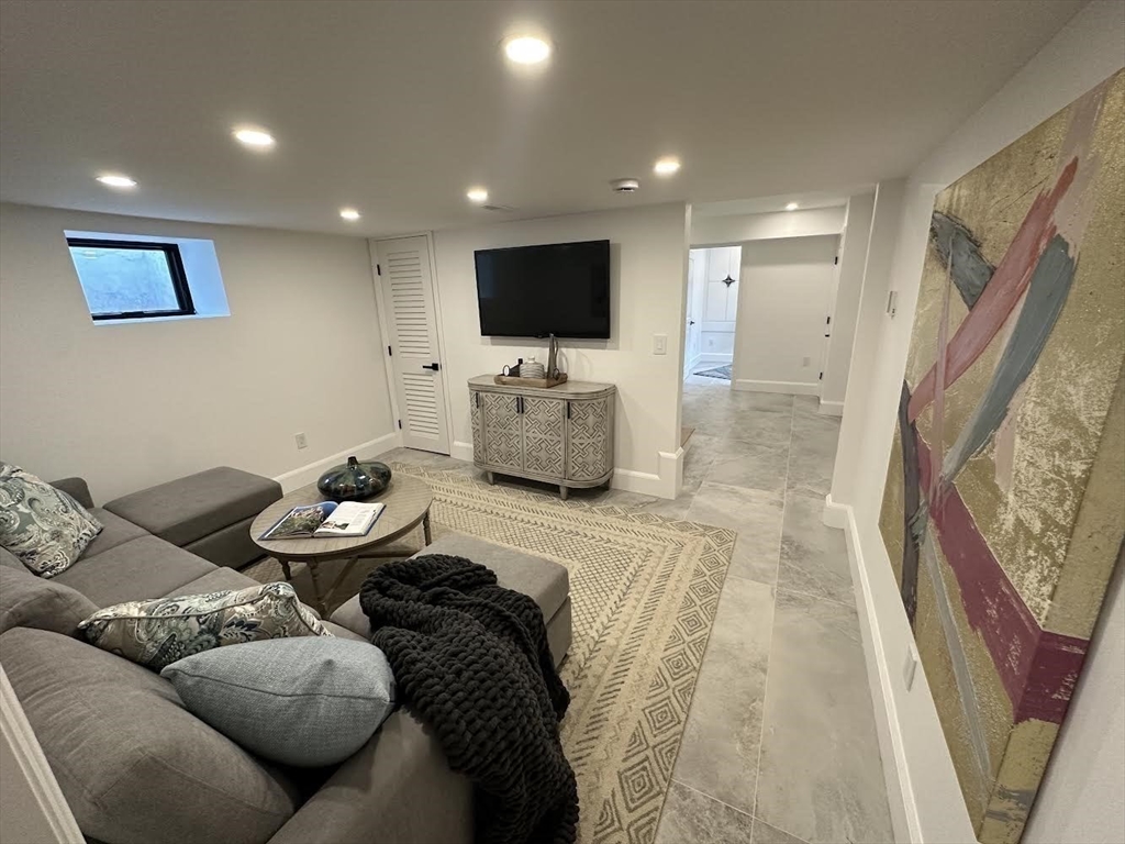 31 Lancaster Road Newton, MA 02458 - Photo 23 of 30 a living room with furniture and a flat screen tv
