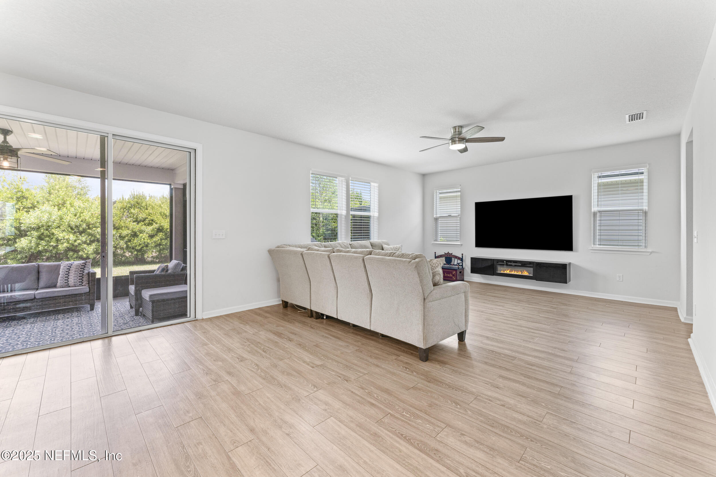 513 Sandstone Drive St. Augustine, FL 32086 - Photo 11 of 56 a living room with furniture and a flat screen tv