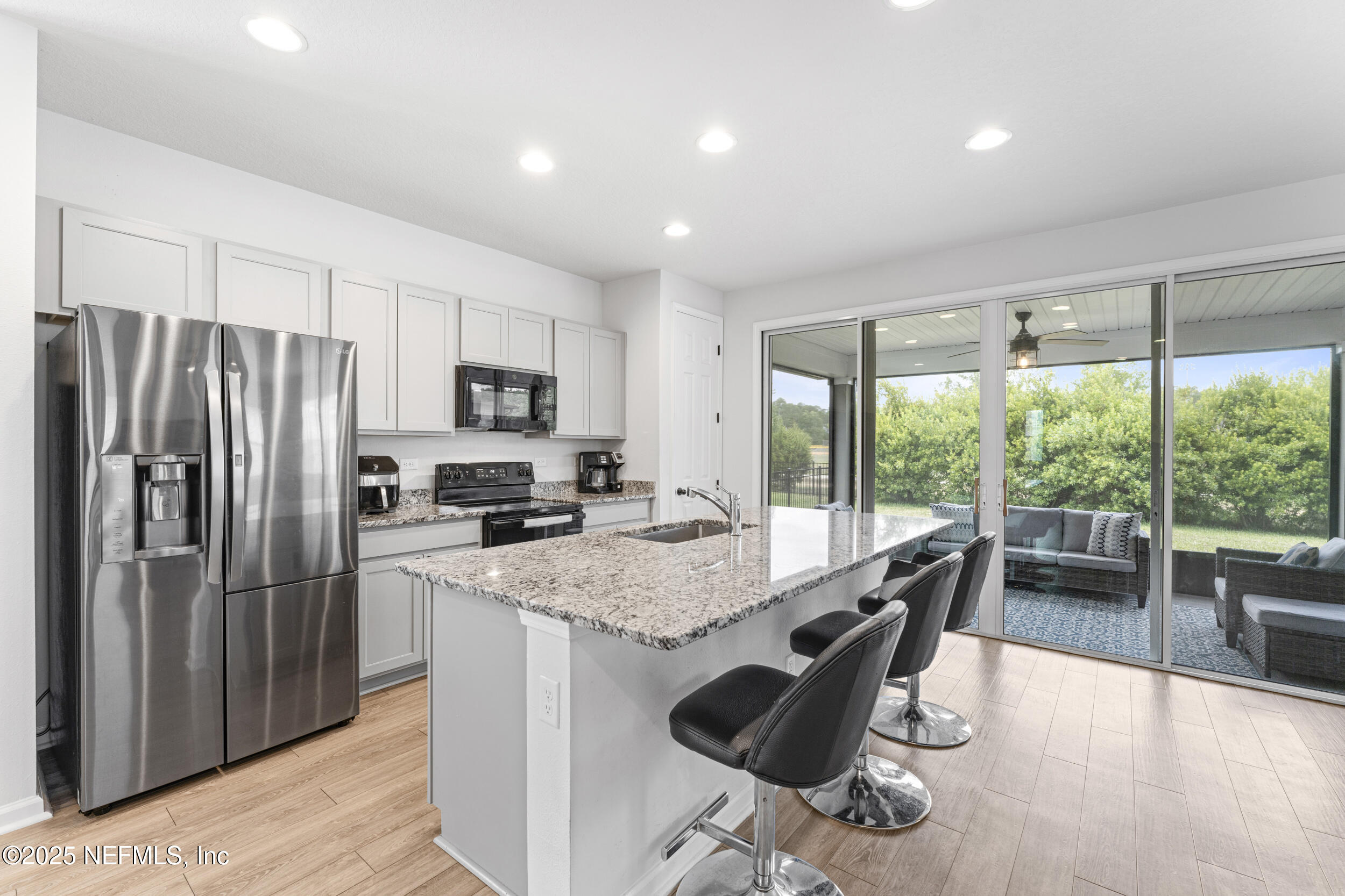 513 Sandstone Drive St. Augustine, FL 32086 - Photo 13 of 56 a kitchen with kitchen island a large counter top space appliances and cabinets