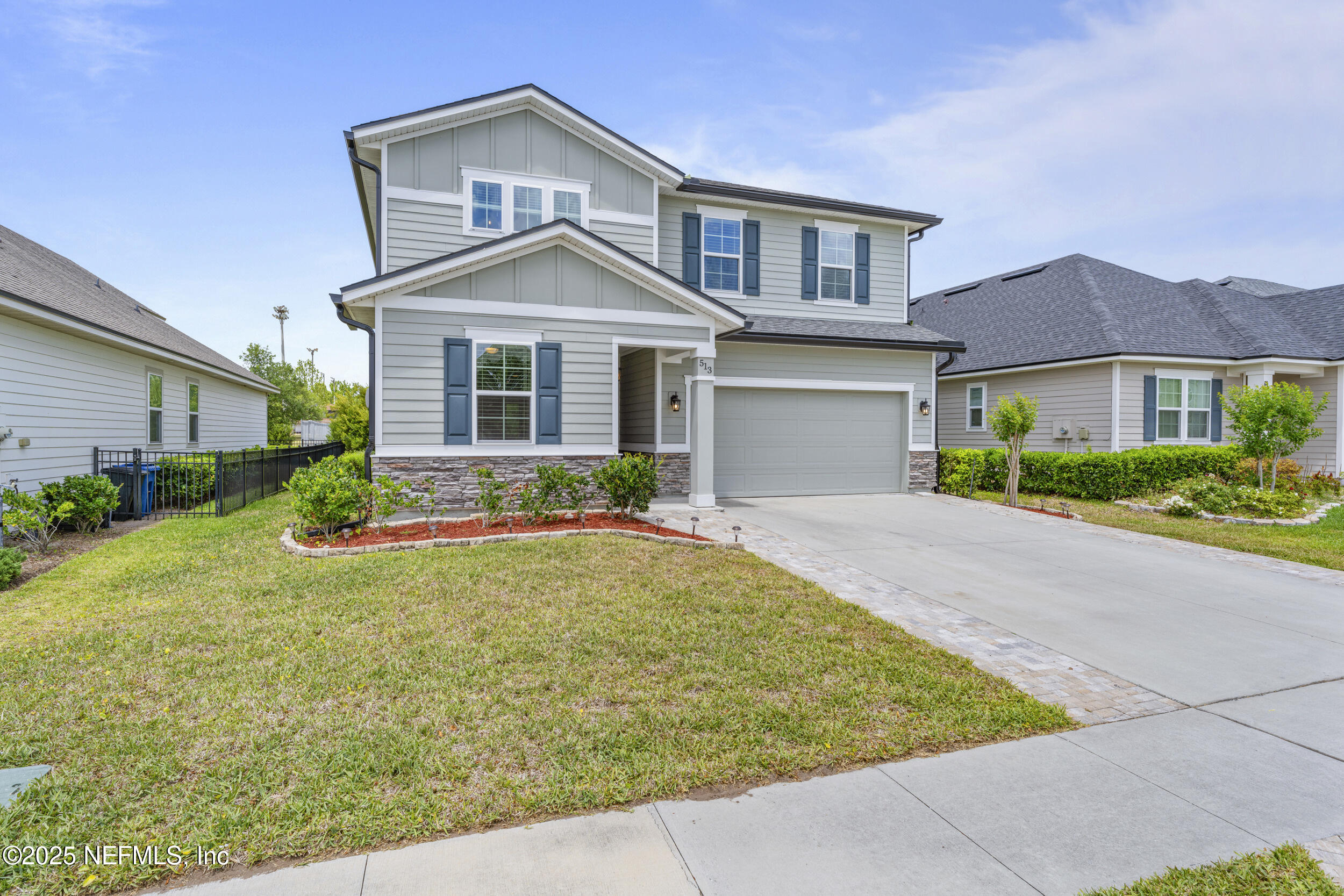 513 Sandstone Drive St. Augustine, FL 32086 - Photo 2 of 56 a front view of a house with yard and green space