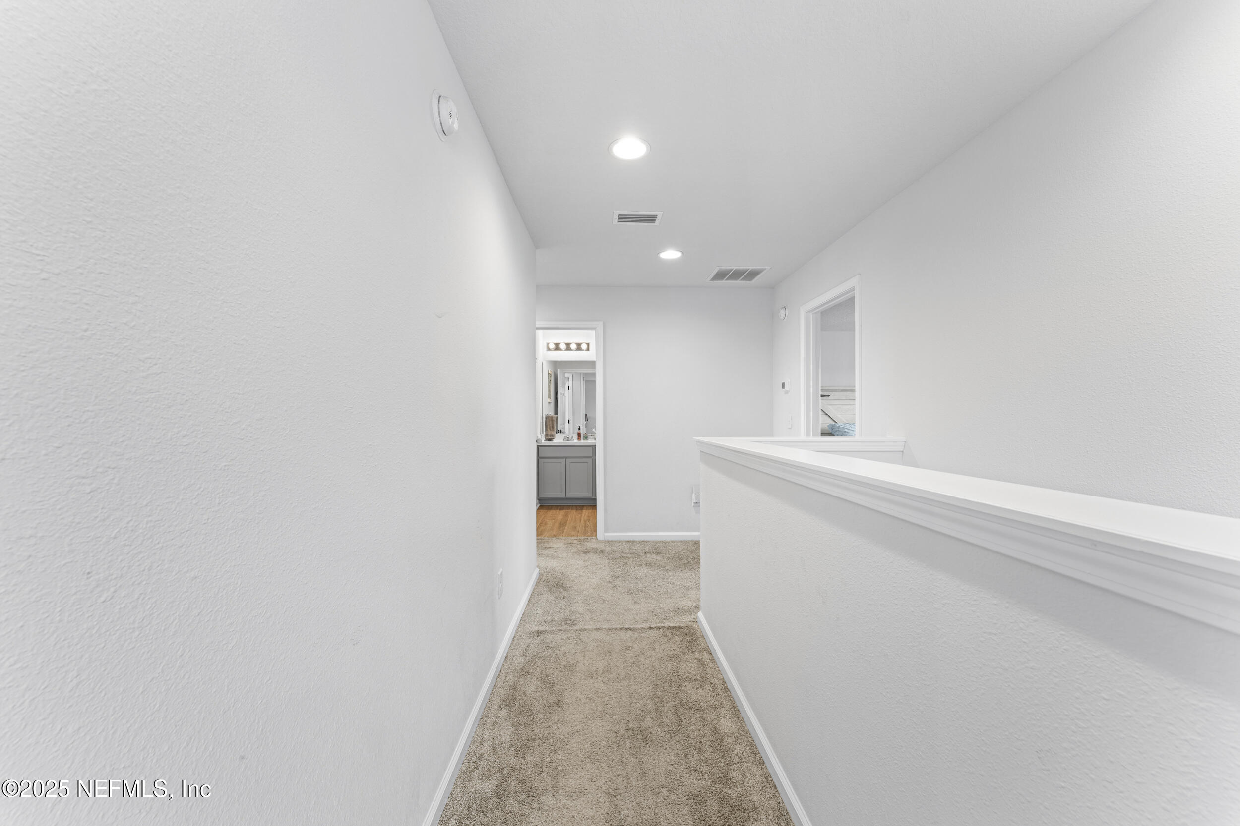 513 Sandstone Drive St. Augustine, FL 32086 - Photo 21 of 56 a view of a hallway with wooden floor and staircase