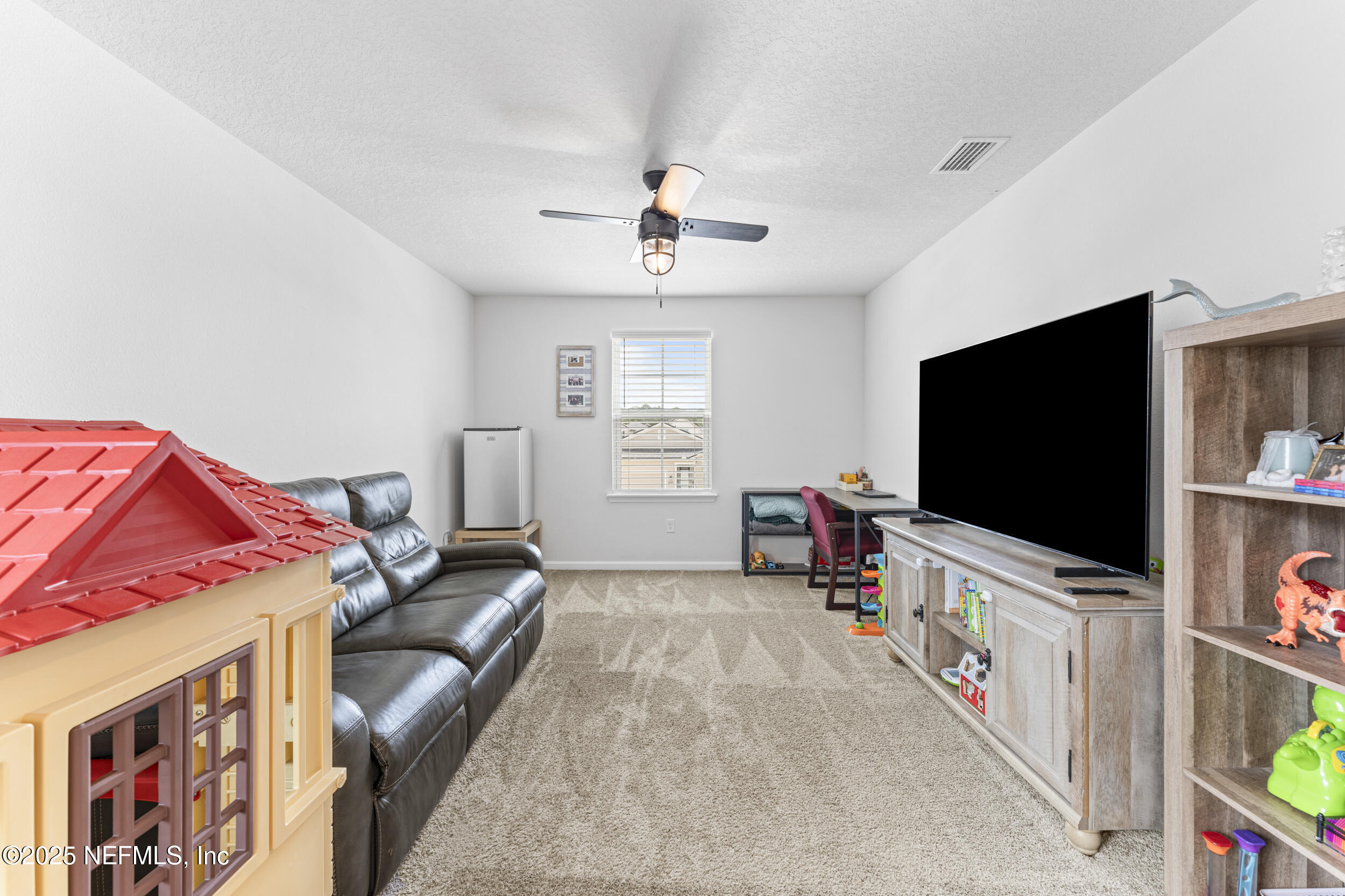 513 Sandstone Drive St. Augustine, FL 32086 - Photo 22 of 56 a living room with furniture and a flat screen tv