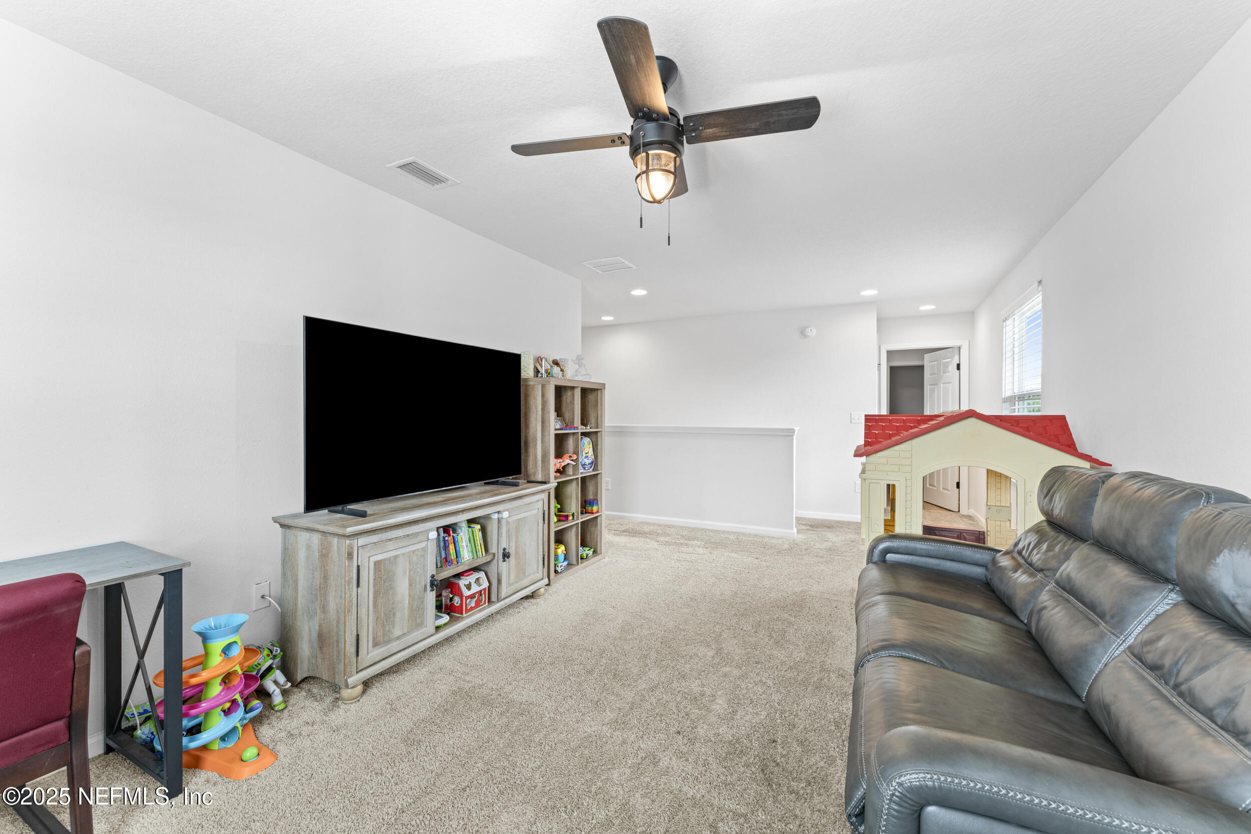 513 Sandstone Drive St. Augustine, FL 32086 - Photo 23 of 56 a living room with furniture and a flat screen tv