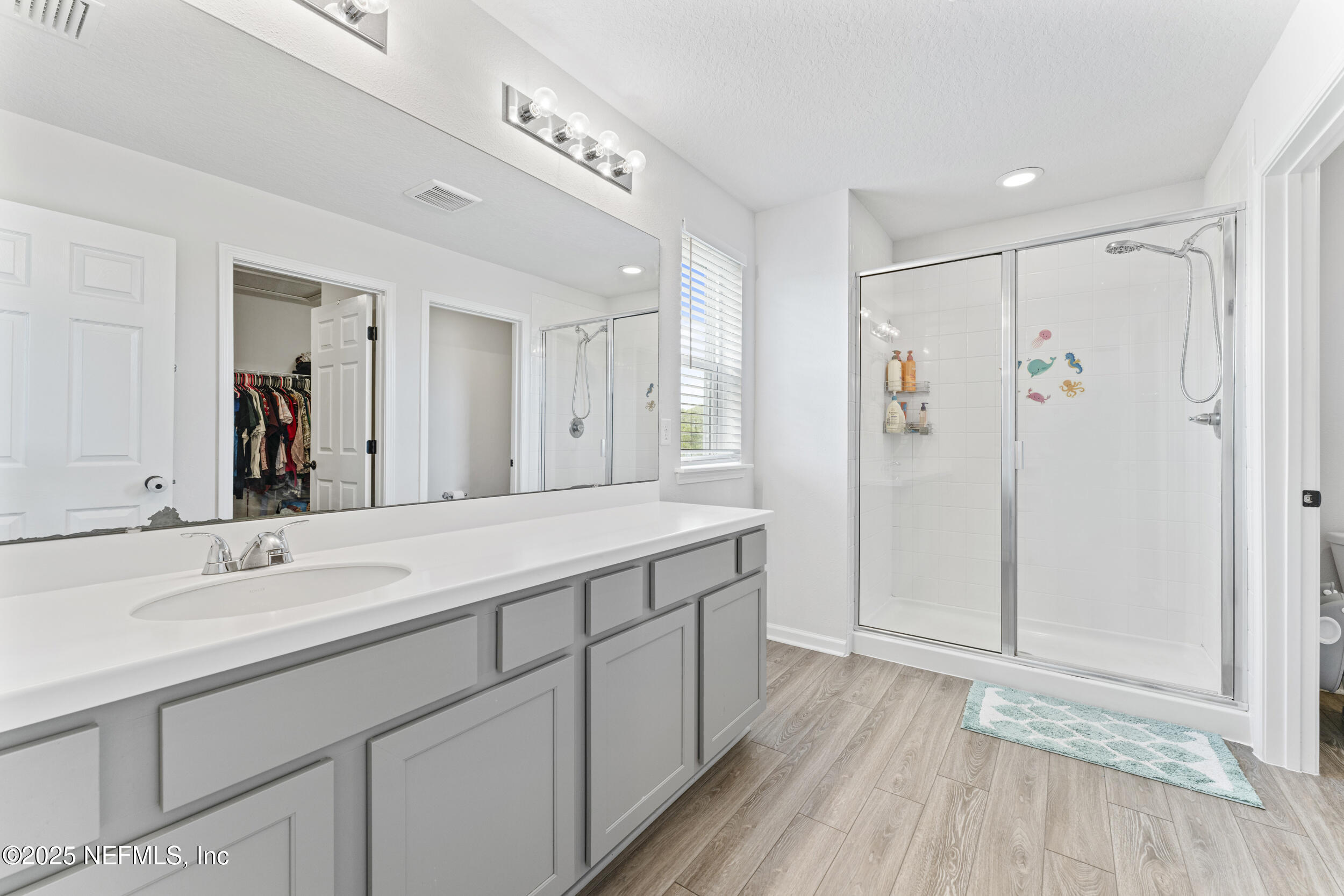 513 Sandstone Drive St. Augustine, FL 32086 - Photo 26 of 56 a spacious bathroom with a shower sink and mirror