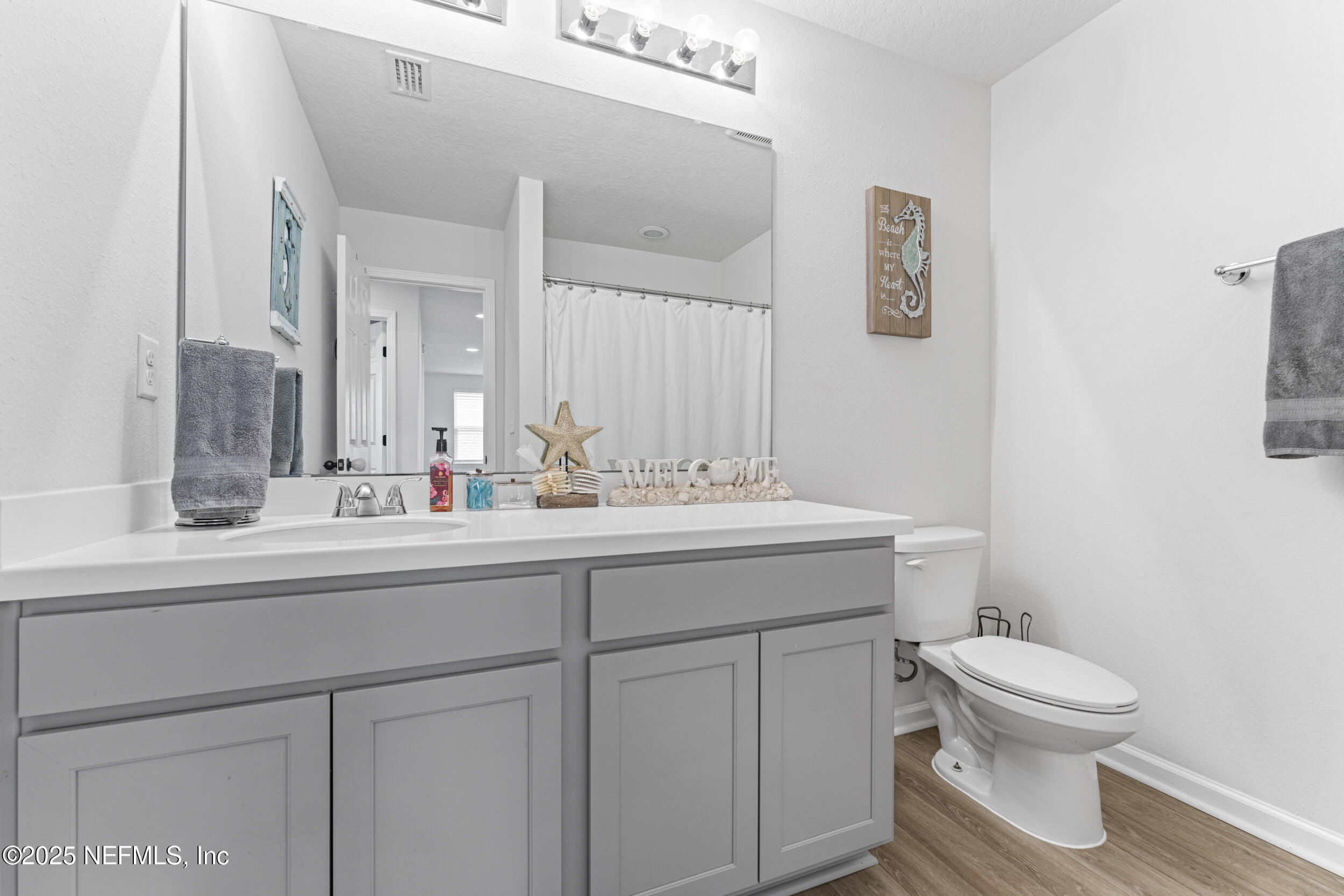 513 Sandstone Drive St. Augustine, FL 32086 - Photo 29 of 56 a bathroom with a toilet a sink and mirror