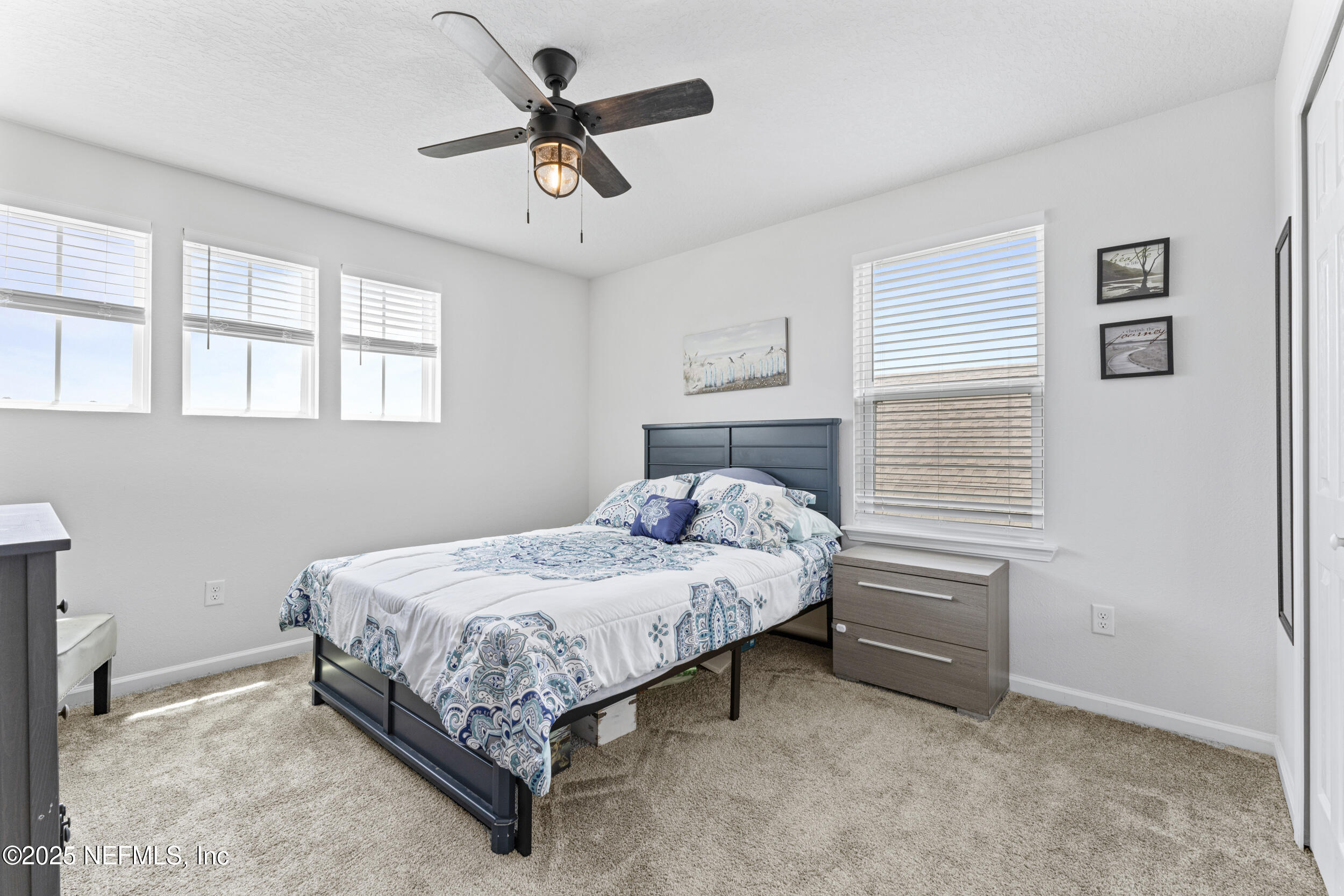 513 Sandstone Drive St. Augustine, FL 32086 - Photo 30 of 56 a bedroom with a bed and a chandelier