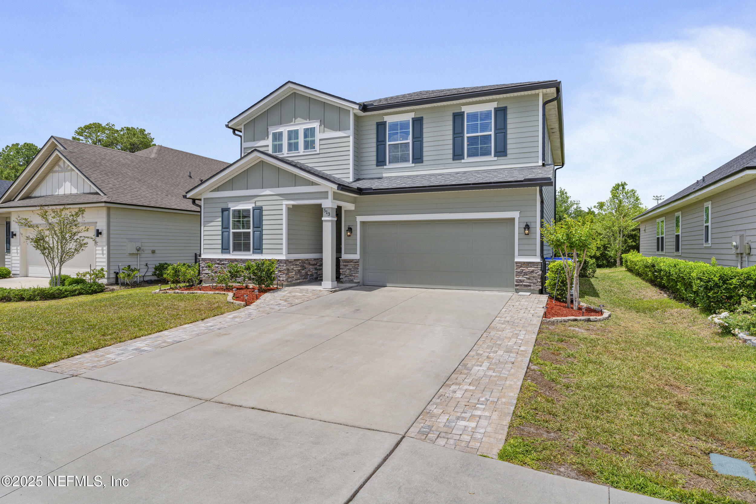 513 Sandstone Drive St. Augustine, FL 32086 - Photo 3 of 56 a front view of a house with a yard and garage