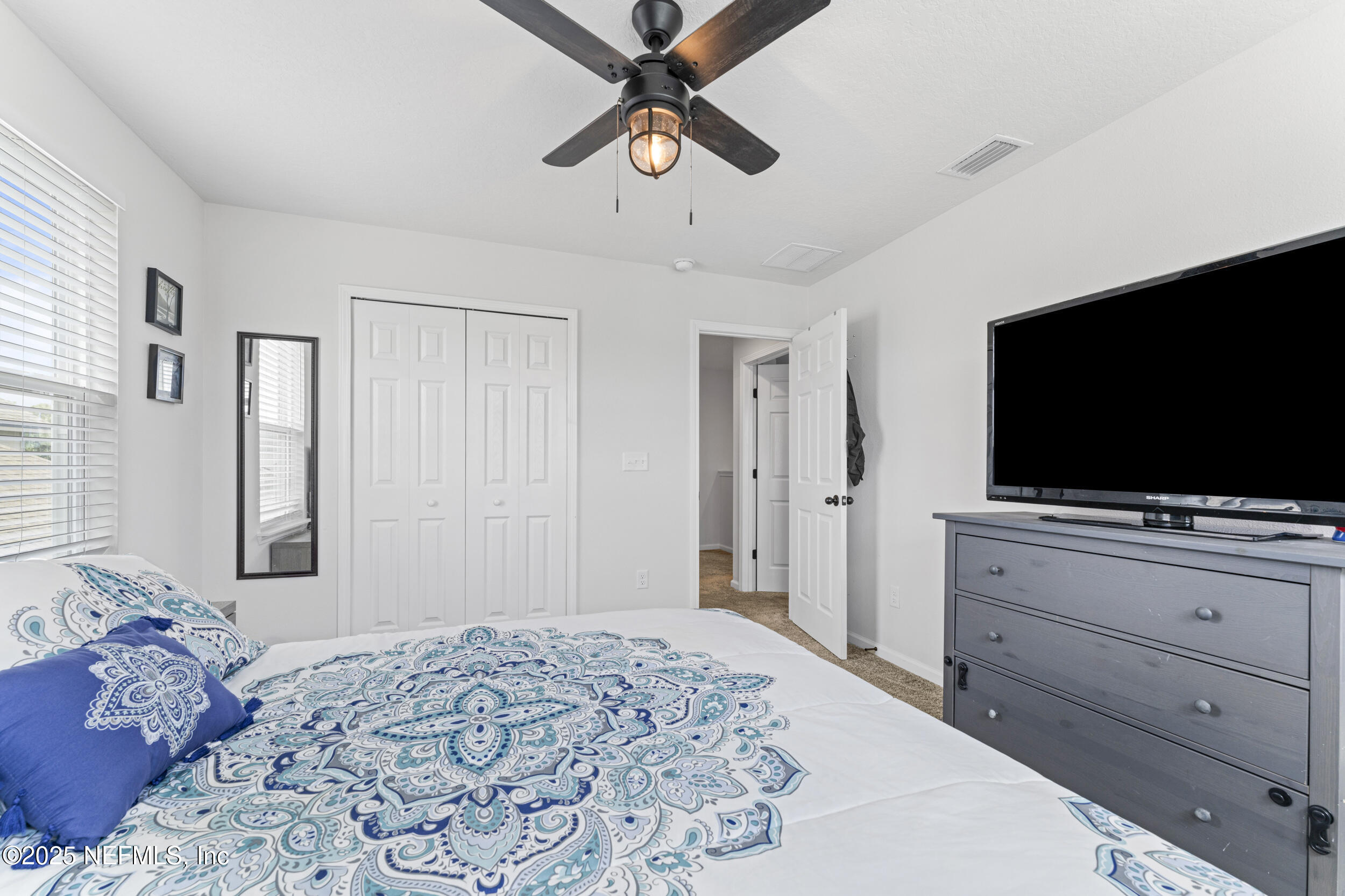 513 Sandstone Drive St. Augustine, FL 32086 - Photo 31 of 56 a bedroom with a bed and a flat screen tv