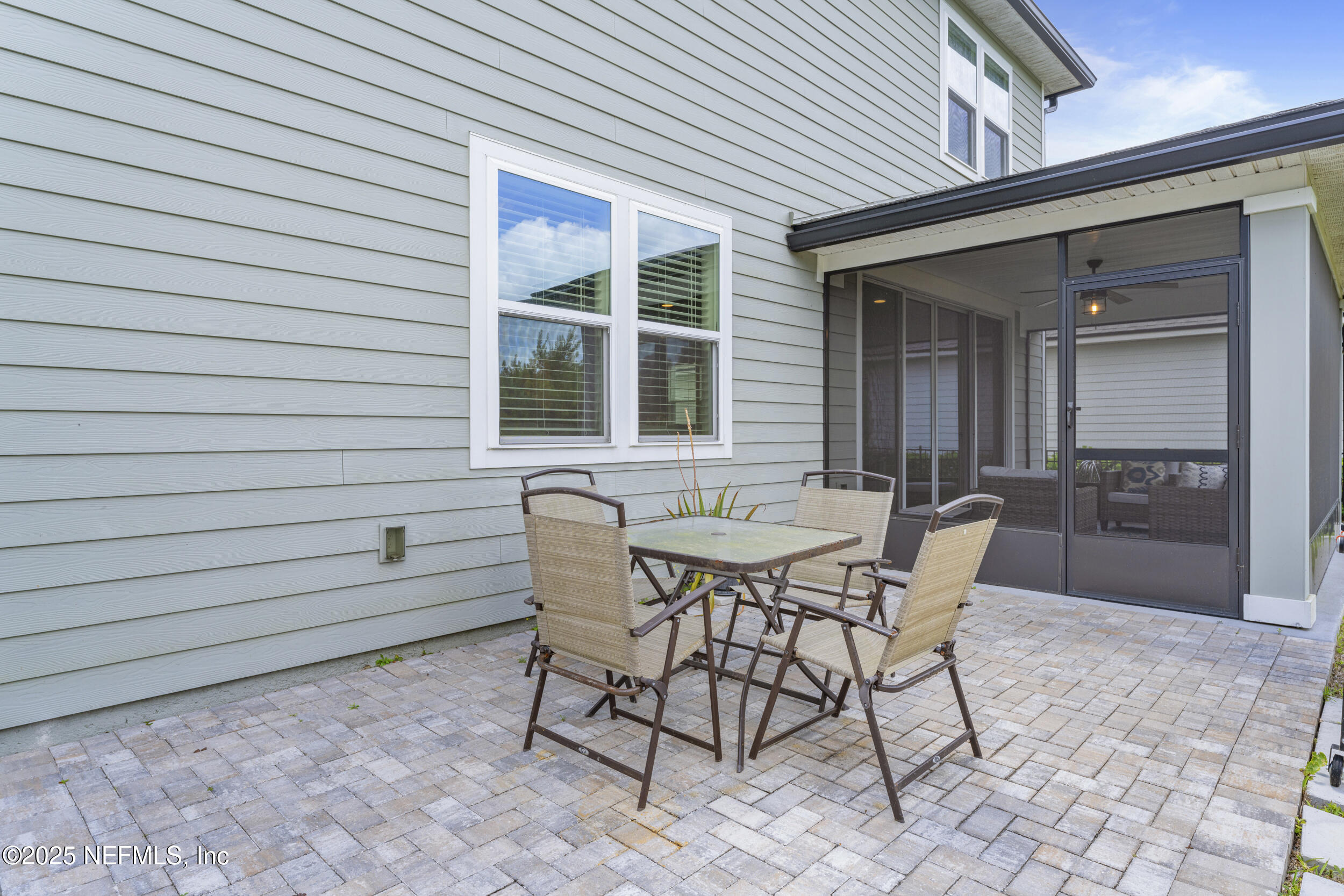 513 Sandstone Drive St. Augustine, FL 32086 - Photo 35 of 56 a view of a patio with a table and chairs