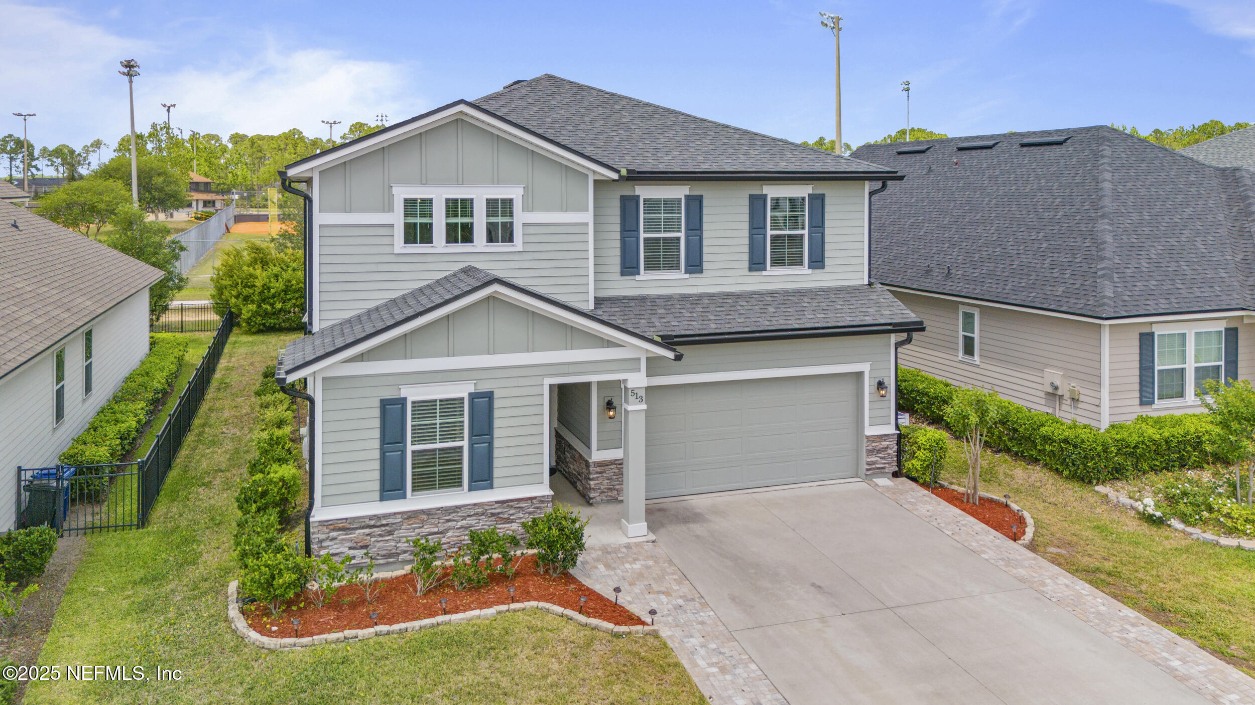 513 Sandstone Drive St. Augustine, FL 32086 - Photo 39 of 56 a front view of a house with a yard and garage