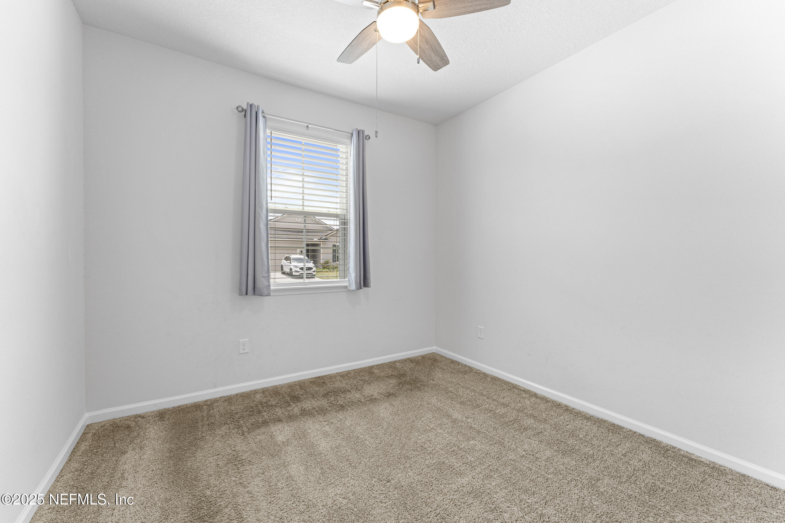 513 Sandstone Drive St. Augustine, FL 32086 - Photo 7 of 56 an empty room with a window