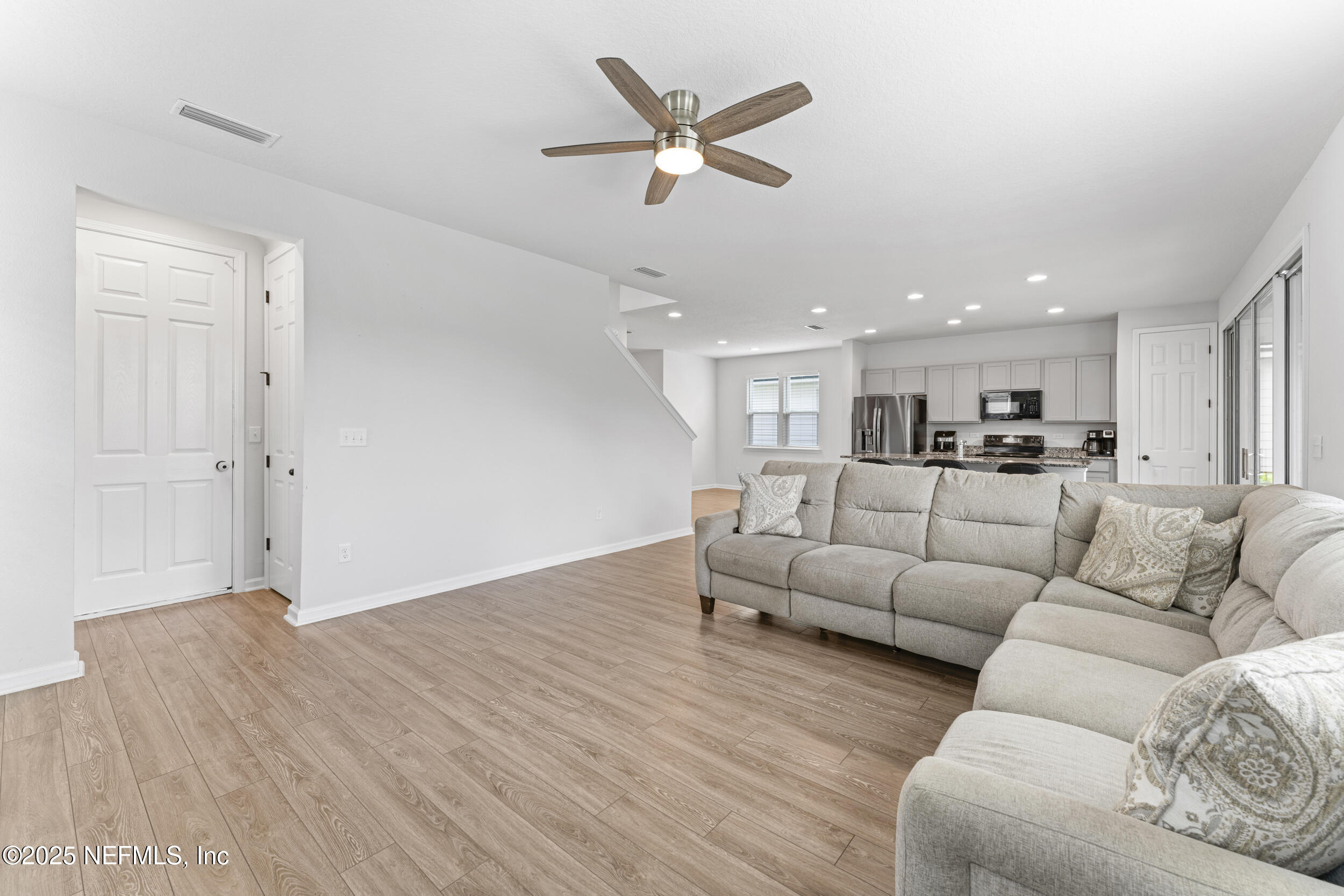 513 Sandstone Drive St. Augustine, FL 32086 - Photo 9 of 56 a living room with furniture kitchen view and a wooden floor