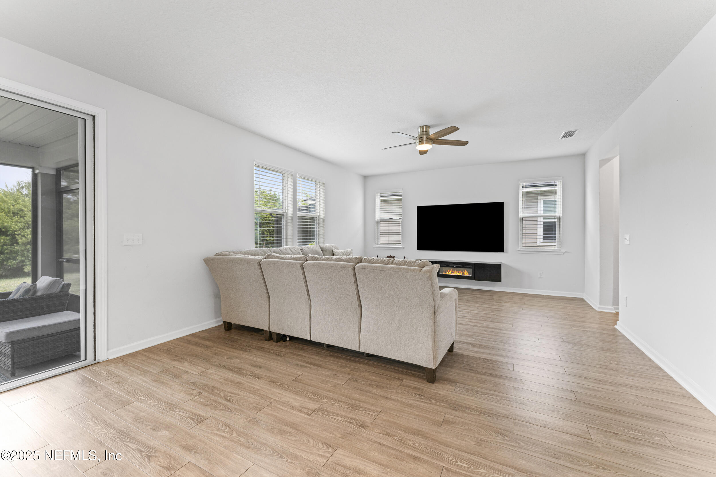 513 Sandstone Drive St. Augustine, FL 32086 - Photo 10 of 56 a living room with furniture and a flat screen tv