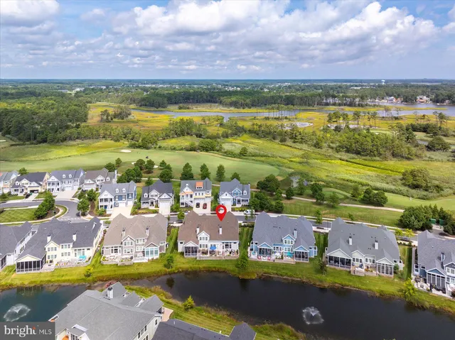 a view of a hallway with wooden floor and a potted plant
