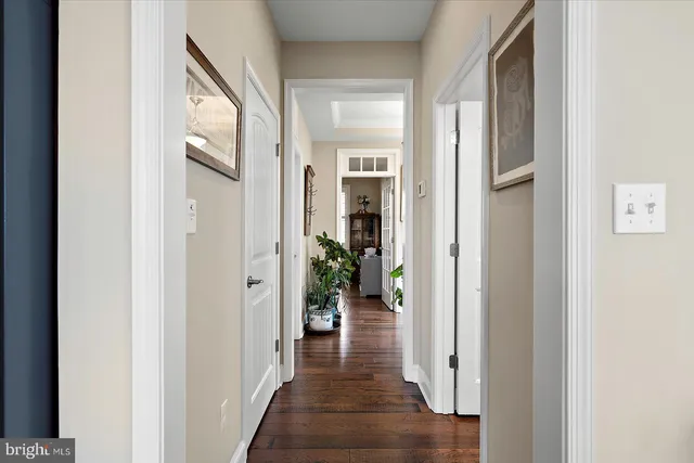 a living room with furniture a flat screen tv and a table