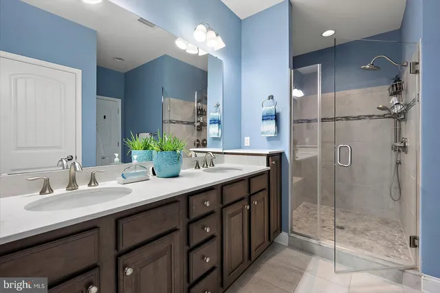 a bathroom with a double vanity sink mirror and double