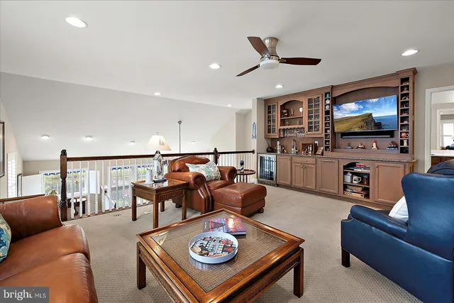 a view of a patio with couches table and chairs and potted plants
