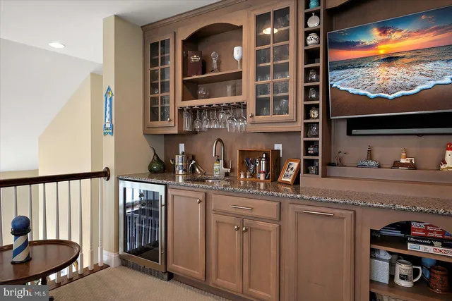a view of a patio with couches and a dining table and chairs with wooden floor