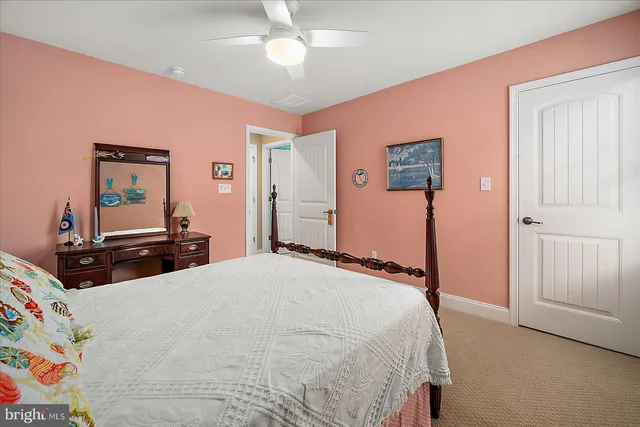 a front view of a house with a yard and potted plants