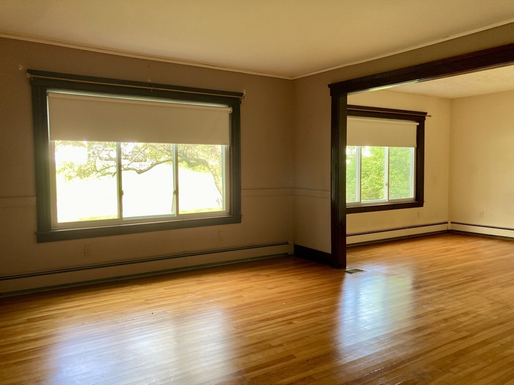 124 Bailey Road Holden, MA 01520 - Photo 13 of 37 a view of an empty room with wooden floor and a window