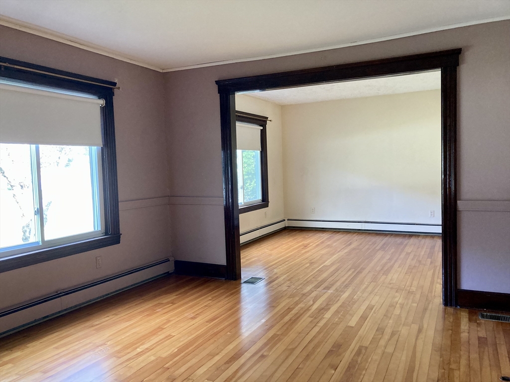 124 Bailey Road Holden, MA 01520 - Photo 14 of 37 an empty room with wooden floor and windows