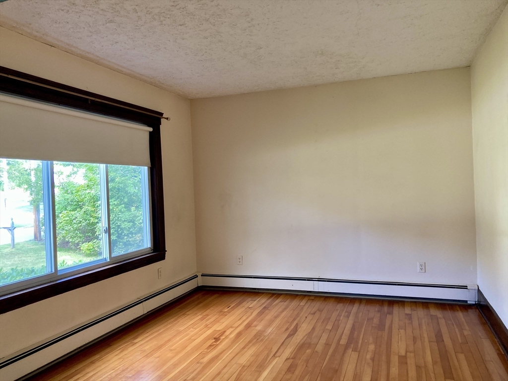 124 Bailey Road Holden, MA 01520 - Photo 15 of 37 a view of a room with wooden floor and a window