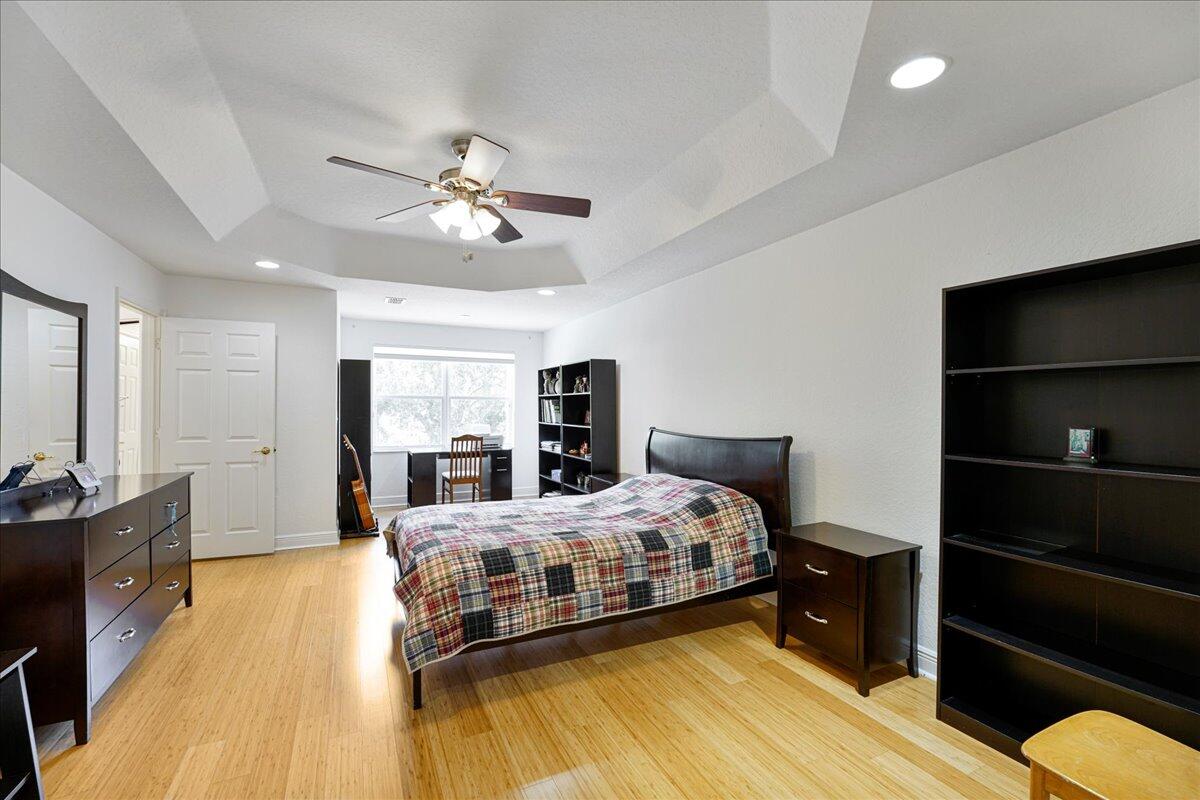 19059 Skyridge Circle Boca Raton, FL 33498 - Photo 27 of 40 a bedroom with a bed and wooden floor